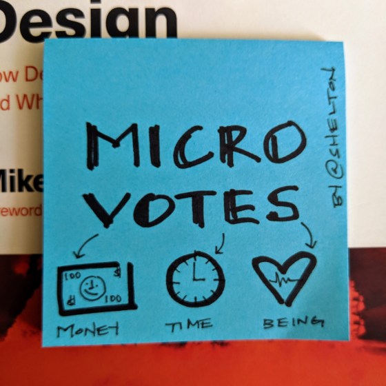 Sticky note with micro-votes written on it with a sharpie marker